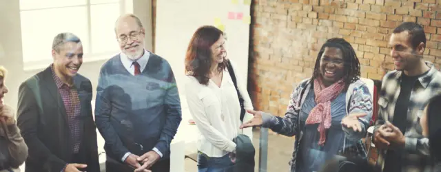 Group of people talking and smiling
